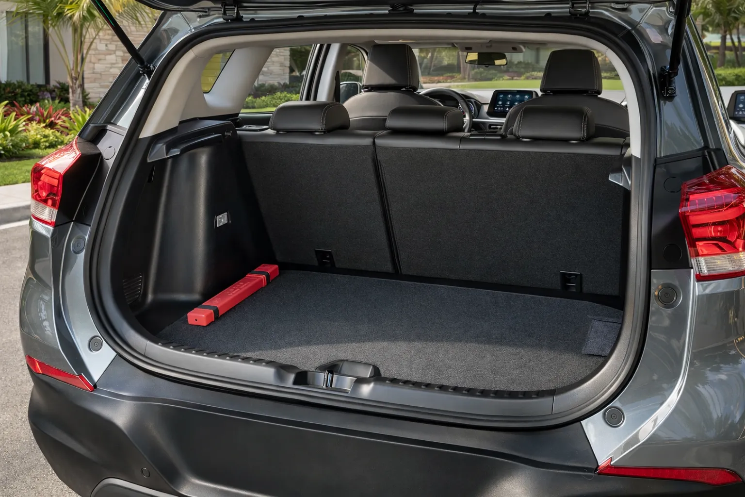 Porta-malas aberto com vista para a casa